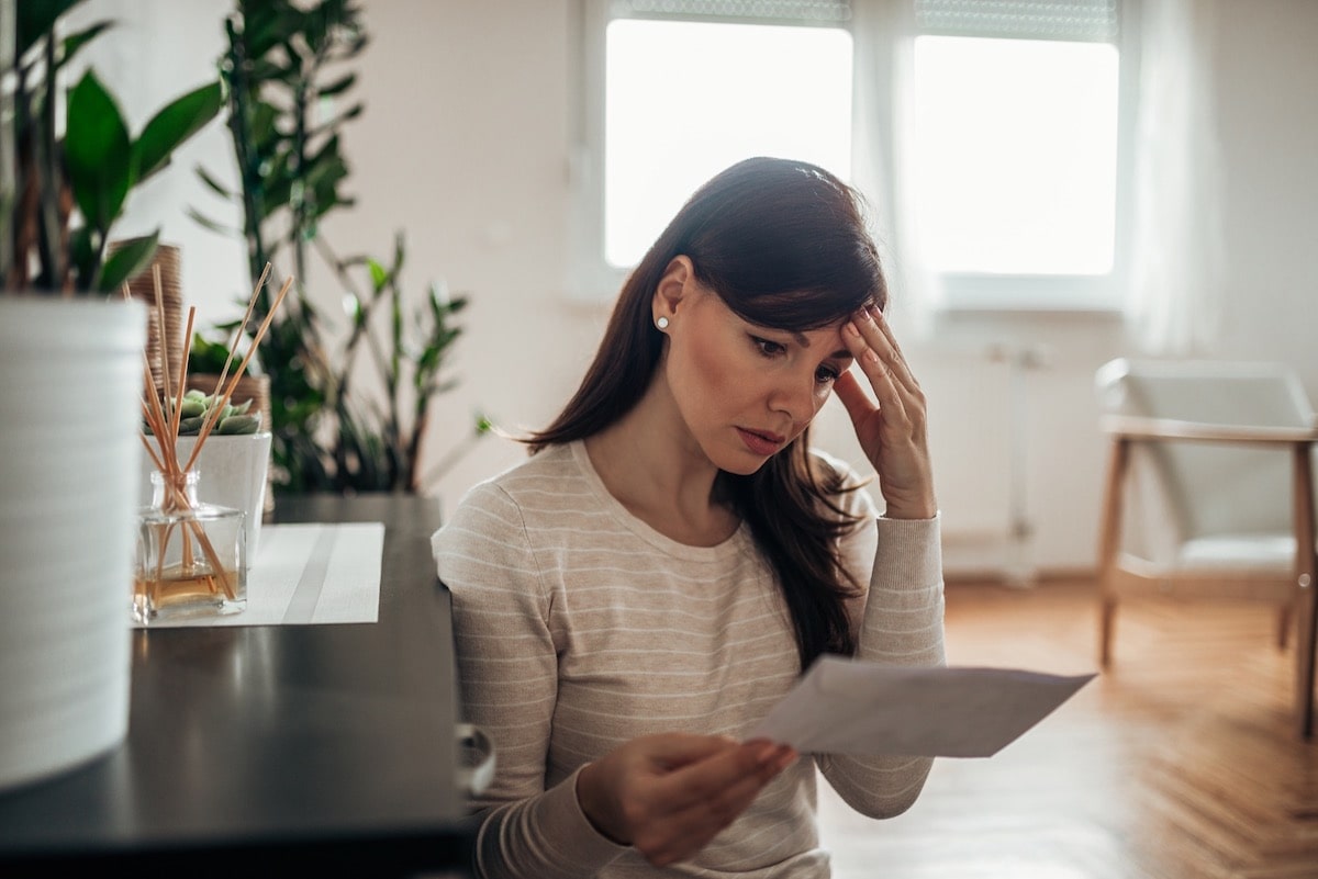 An upset woman reading documents