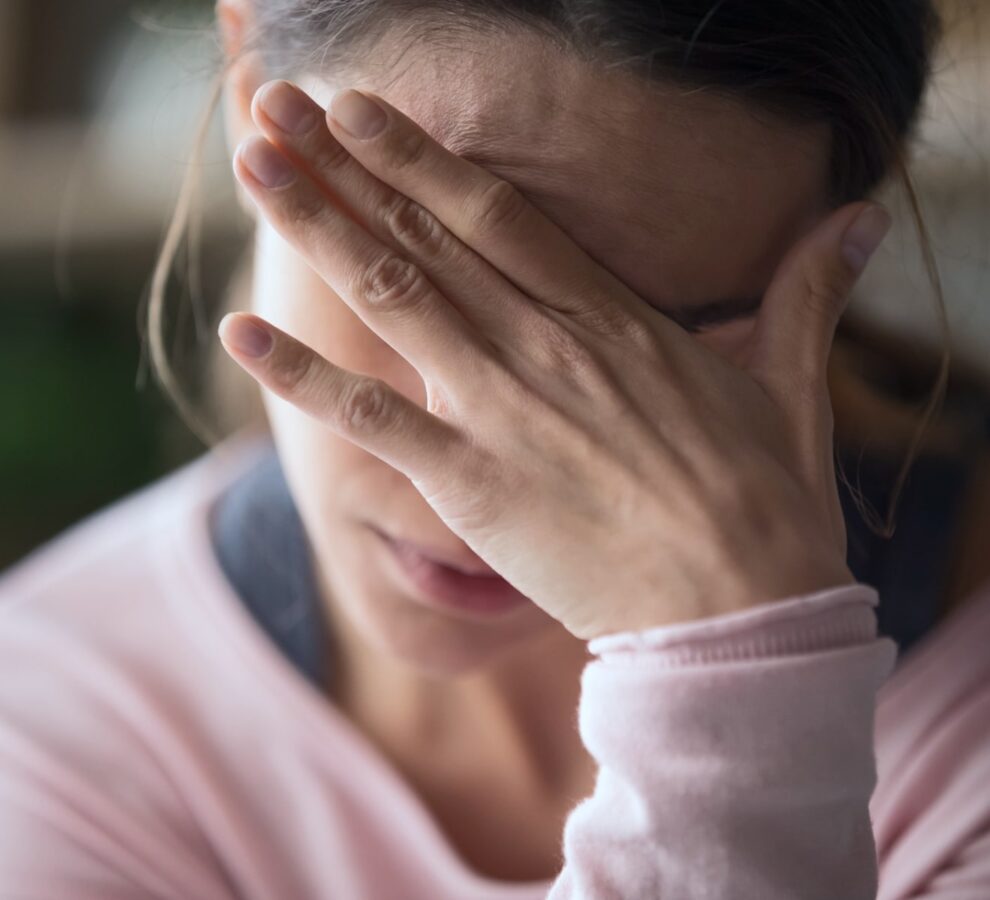 Headache After Injury Stressed woman holding her head