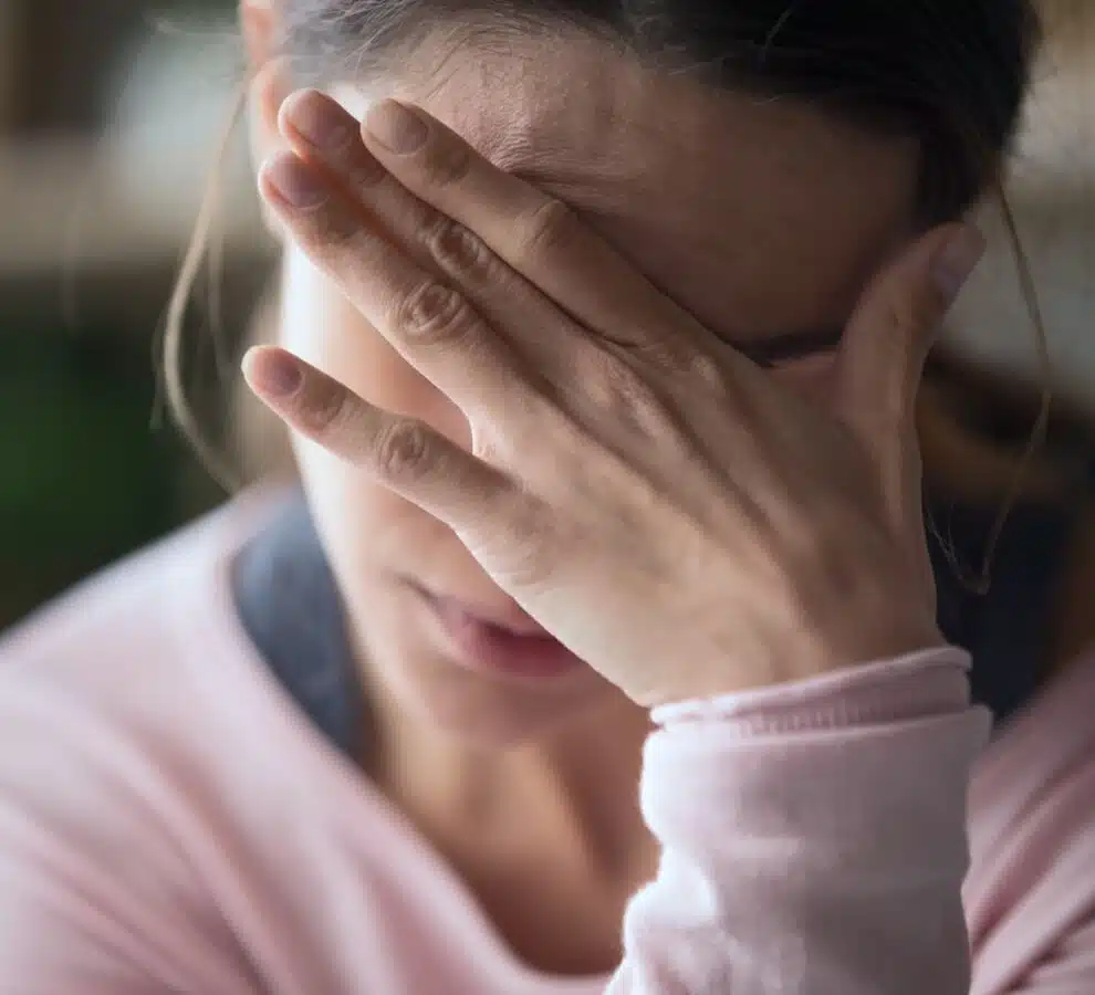Headache After Injury Stressed woman holding her head