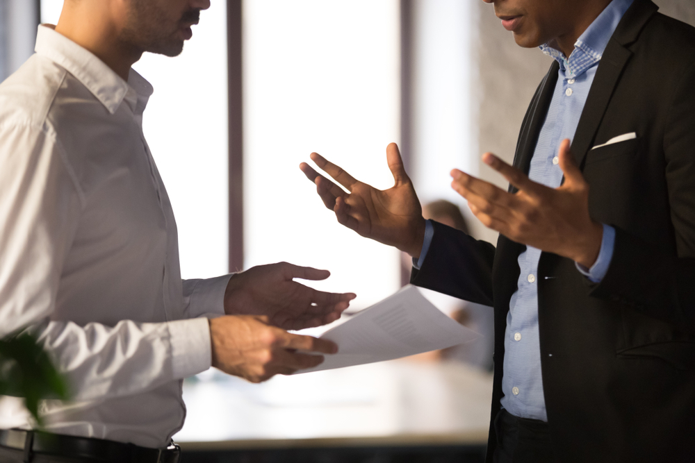 Photo of Two Employees Conversing