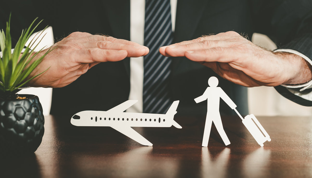 Insurer protecting a traveller with his hands