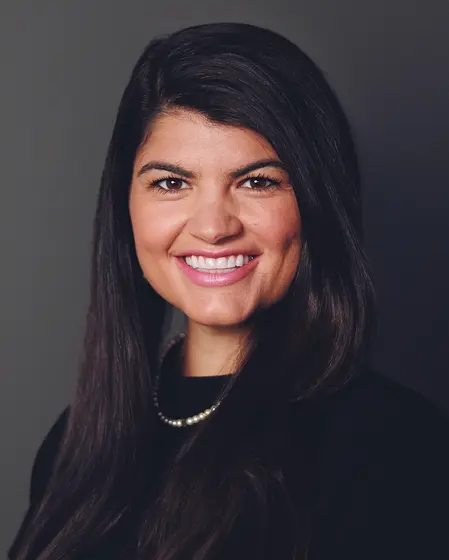Professional headshot of Pari Morgan, woman with long dark hair wearing black blazer and pearl necklace.